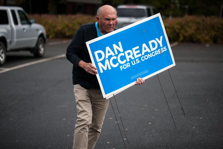 A man holding a "Dan McCready for U.S. Congress" sign.